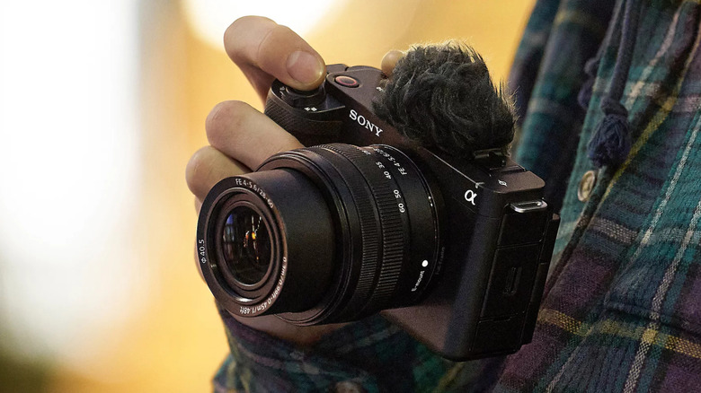 A person holding a Sony ZV-E1 camera