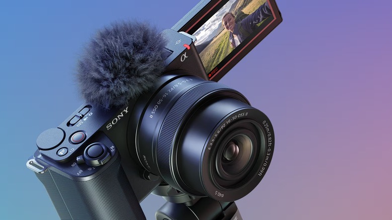 A Sony ZV-E10 II camera in vlogging mode with the screen facing the other way and a microphone installed