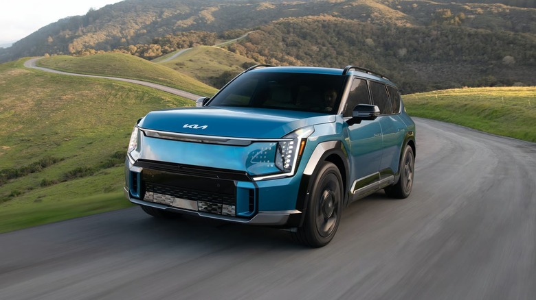 Kia EV9 driving electric vehicle driving on a mountain road