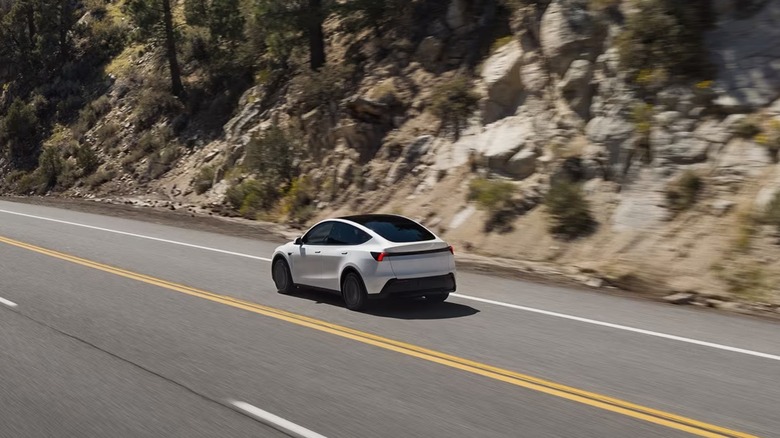 Tesla Model Y electric vehicle driving on a mountain road