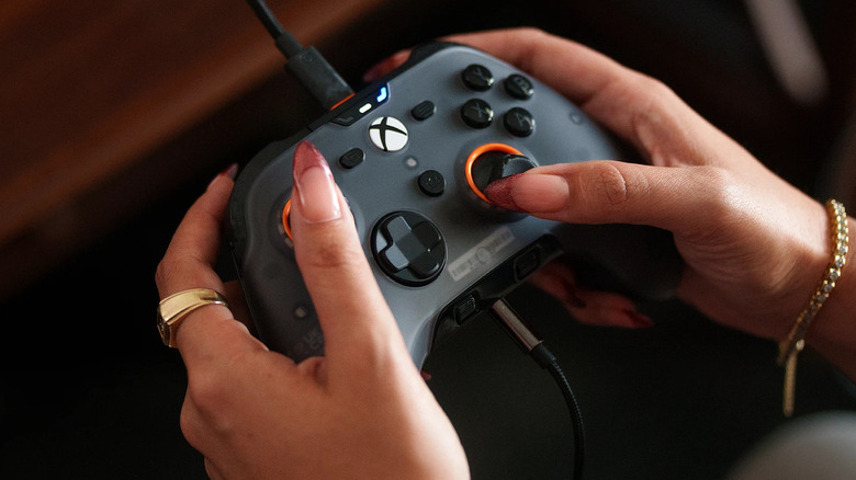 A person holding the SCUF Valor Pro in both hands