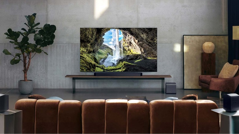 Samsung HW-Q990F placed infront of a TV.