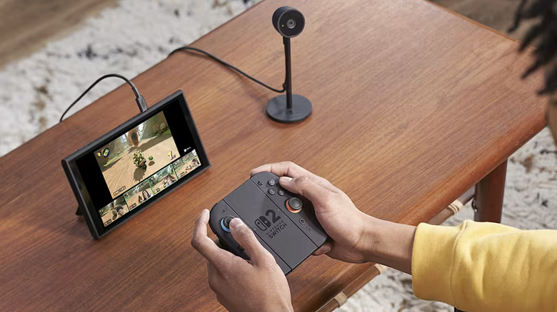 Someone playing Switch 2 in Tabletop Mode with the camera attachment to the side