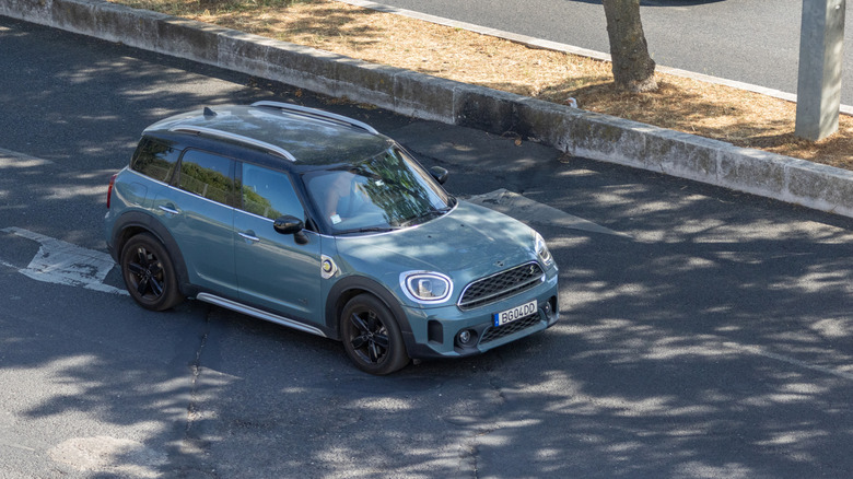 A blue-gray Mini Countryman in the street.