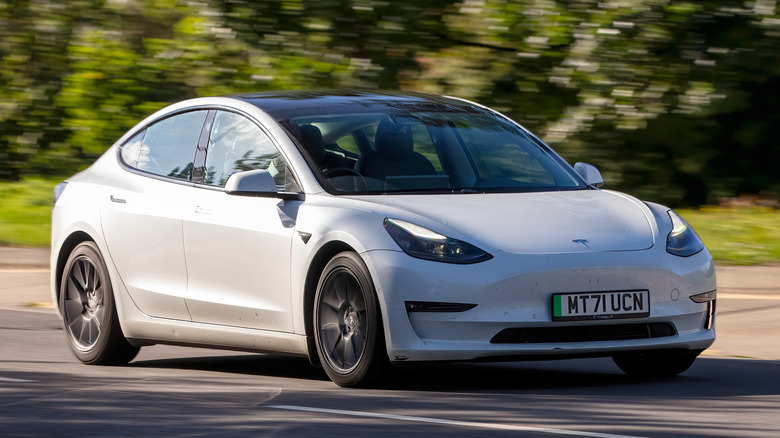 Tesla Model 3 driving on a road
