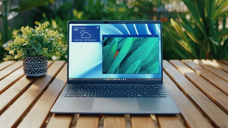 The Dell Latitude 7455 laptop on a table, outdoors.