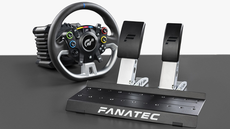 The Fanatec GT DD Pro racing wheel and pedals, placed on a gray surface with a white background