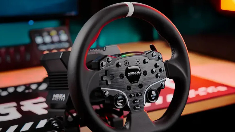 The MOZA R5 steering wheel attached to a desk