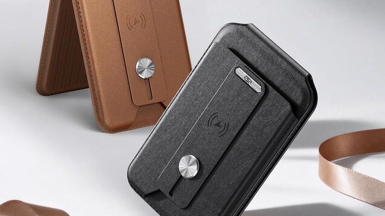 Two small MagSafe wallets in black and brown, one of them propped up as a stand