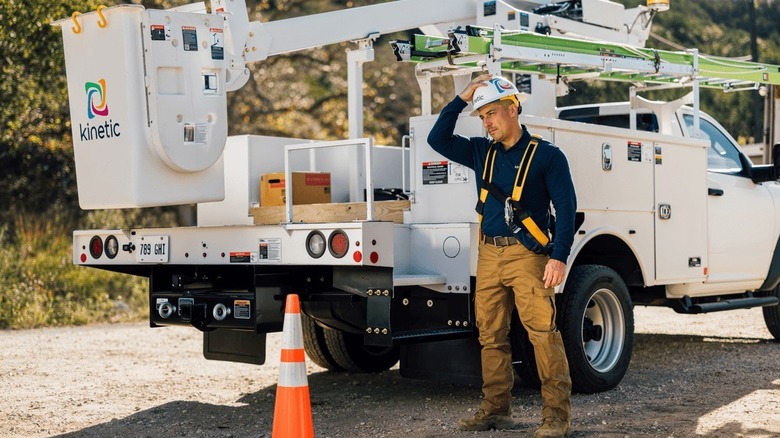 Kinetic service truck with a man standing next to it