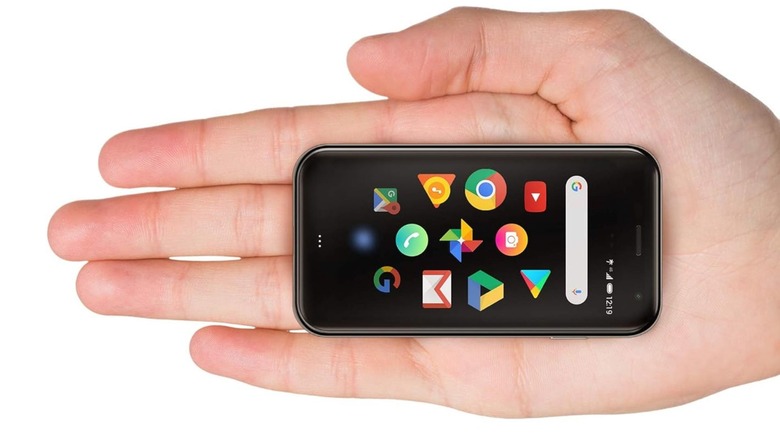 Person holding the tiny Palm Phone in their palm