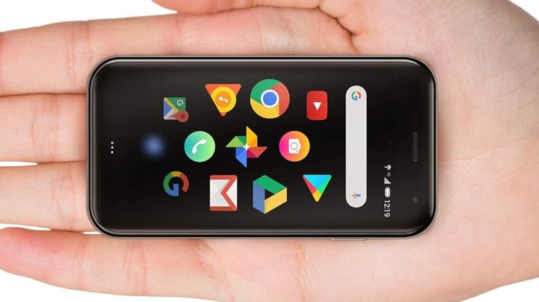 Person holding the tiny Palm Phone in their palm