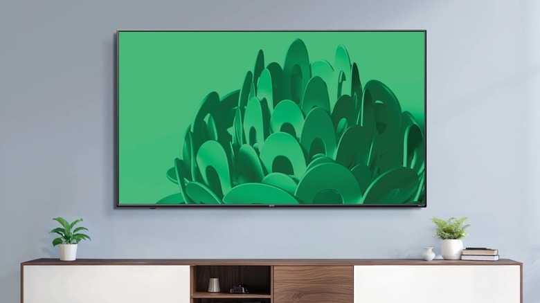 Onn 100012586 4K TV mounted to a wall with TV unit below