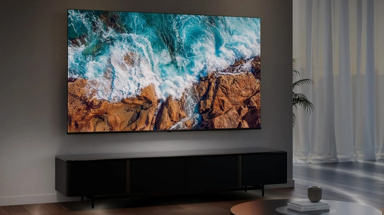 The Hisense 65R6E4 TV mounted to a wall in a living room