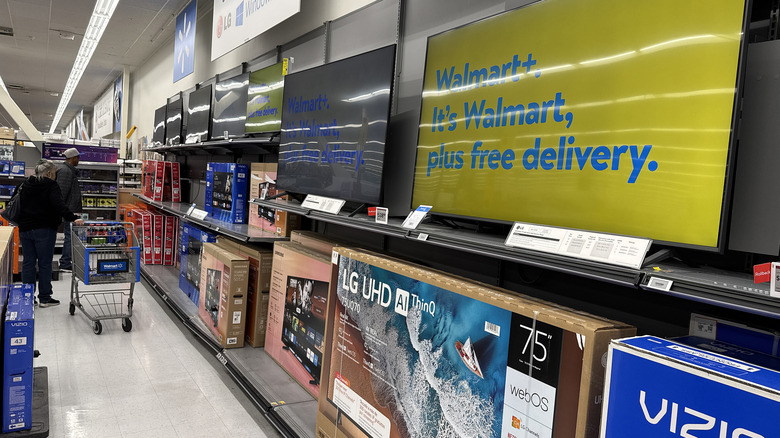 TVs on display inside a Walmart store