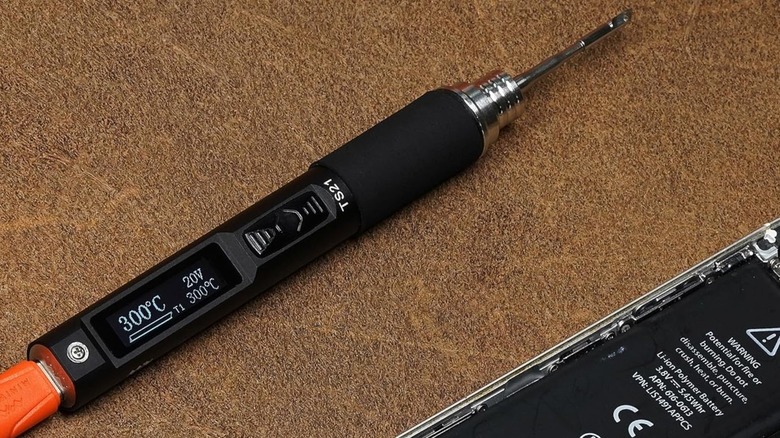 MINIWARE TS21 laying next to phone with rear removed on top of cork mat