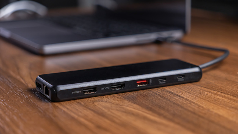 Close-up of a black USB-C docking station with power delivery and multiple display outputs