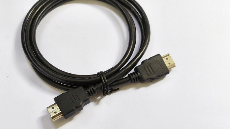 A black HDMI cable on a white background