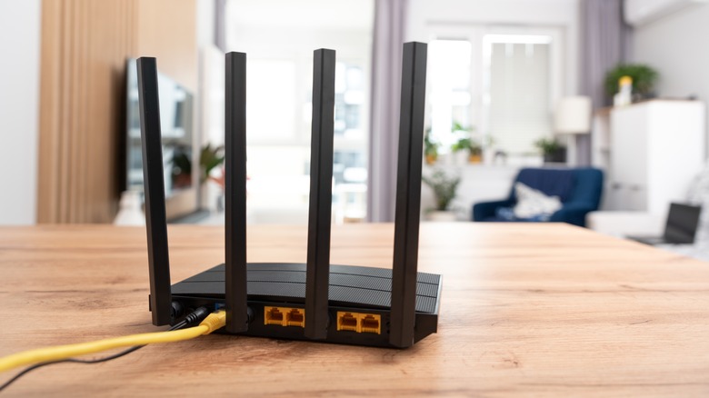 A wi-fi router placed on a wooden table indoors