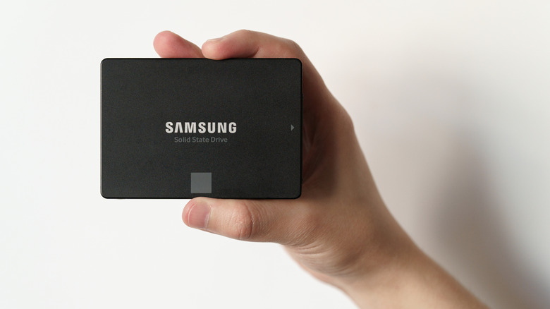 A person holding a Samsung SSD