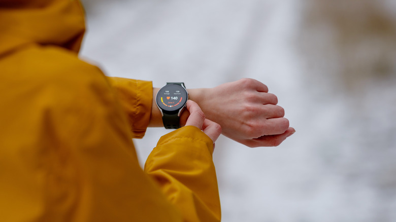 A person adjusting a smartwatch fitness tracker
