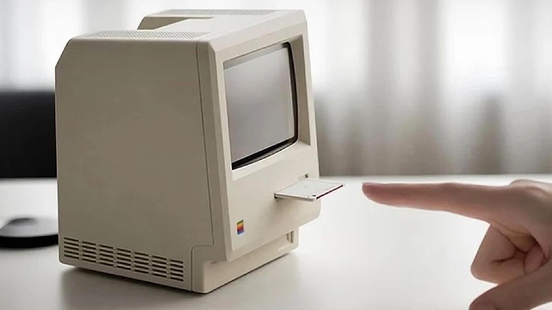 Antpo Maclock mini PC on desk with floppy drive in use.