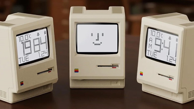 Maclock mini PC replicas on desk in varying styles all facing each other.