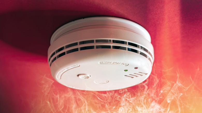 A smoke alarm surrounded by flames.
