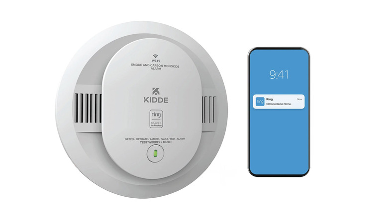 The Kidde Smart Smoke & Carbon Monoxide Alarm on a white background with a phone displaying a Ring notification.