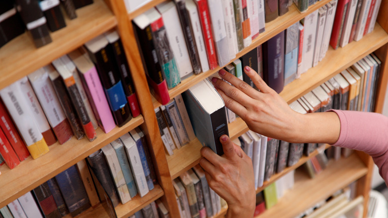 A person selecting books in a store