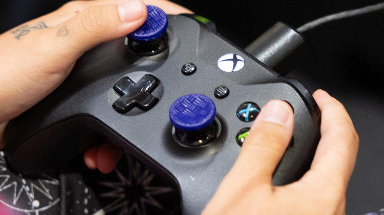 Someone playing a game using an Xbox Wireless Controller