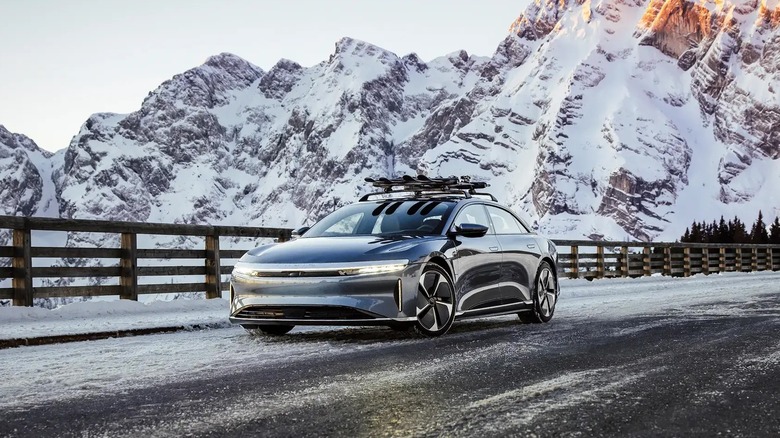 A Lucid Air electric luxury sedan on a snowy mountain road