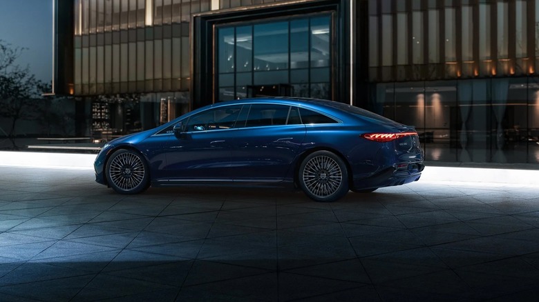 A Mercedes-Benz EQS parked in front of an office building