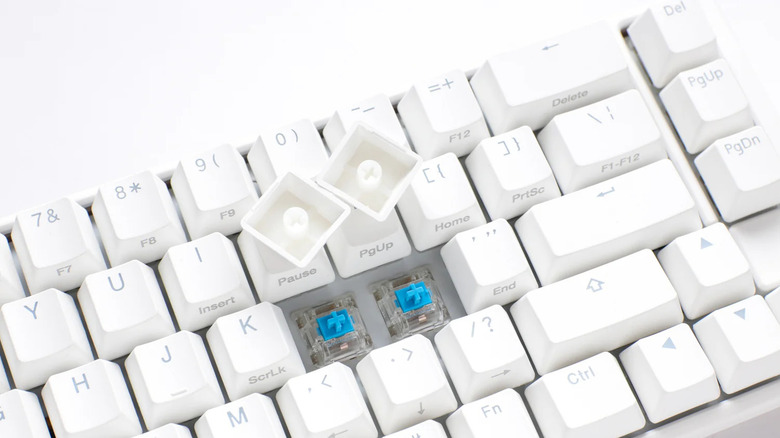 Ducky One 3 SF with two caps removed to show switches underneath