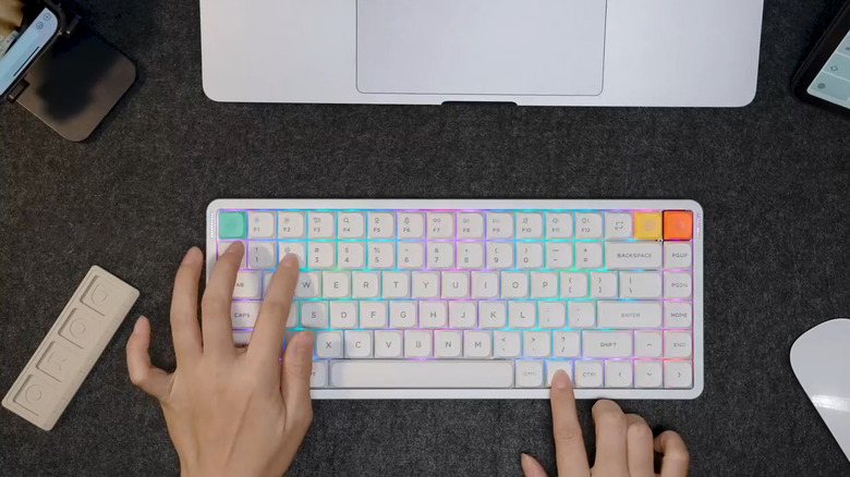 NuPhy Air75 V3 pictured on desk in top-down view with hands above typing
