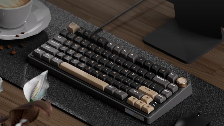 Royal Kludge R75 laying on deskmat on desk showing colorful brown, gray, and black keycaps