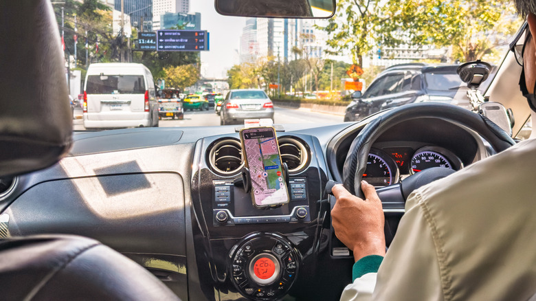 Google Maps show on a phone on the dashboard of a car