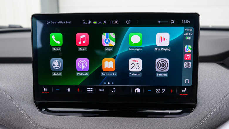 An infotainment screen inside of a vehicle displaying the Apple CarPlay Home screen