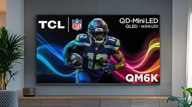 The TCL QM6K wall-mounted in a modern living room