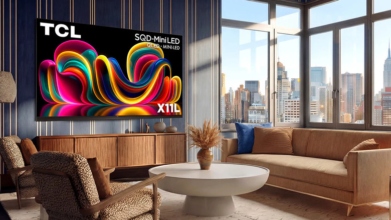 The TCL X11L wall-mounted in a modern living room that overlooks a cityscape