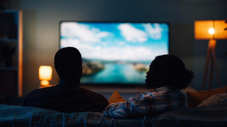 a couple deciding what to watch on their TV