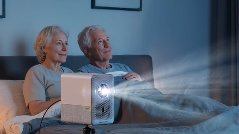 Aurzen EAZZE D1R Cube Roku TV Smart Projector being used to watch TV in a bedroom.