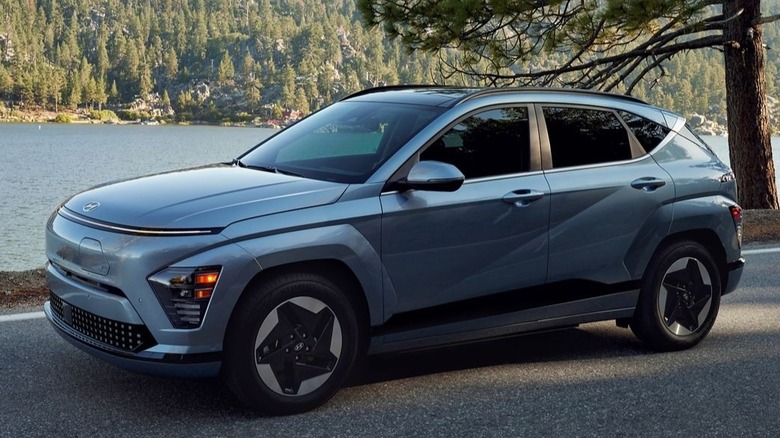 2025 Hyundai Kona electric driving down lakeside street.