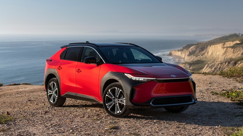 Toyota bZ4X in supersonic red in gravel with two-tone styling.