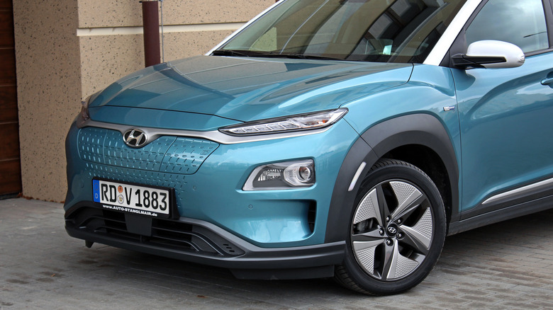 Front view of a blue Hyundai Kona while parked.