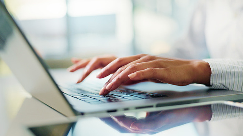 A person typing on a computer