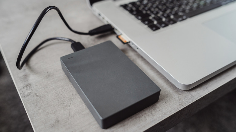 An external drive plugged into a laptop