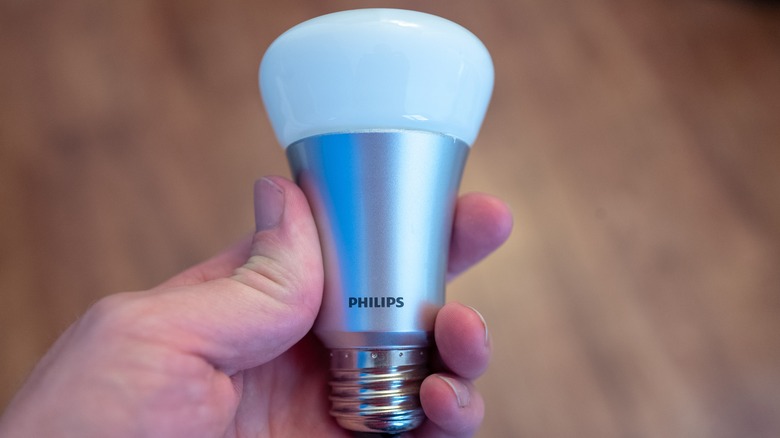 Holding a Philips smart light bulb