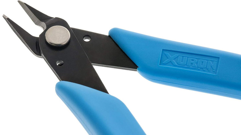 Xuron flush cutters with blue handles shown in close-up.