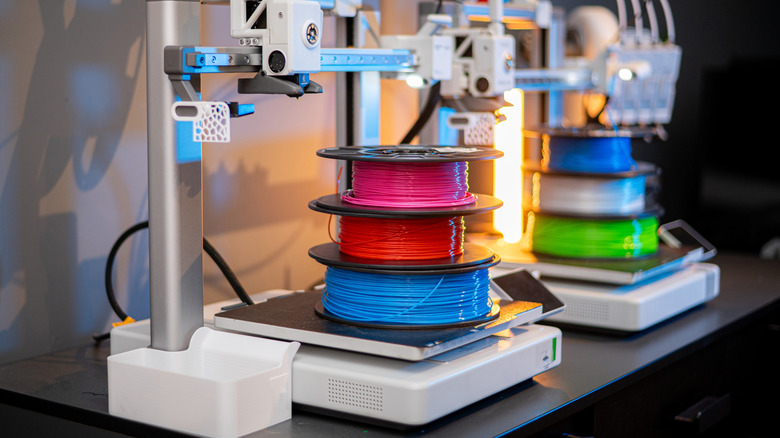 Multicolor filament spools loaded on a 3D printer setup.